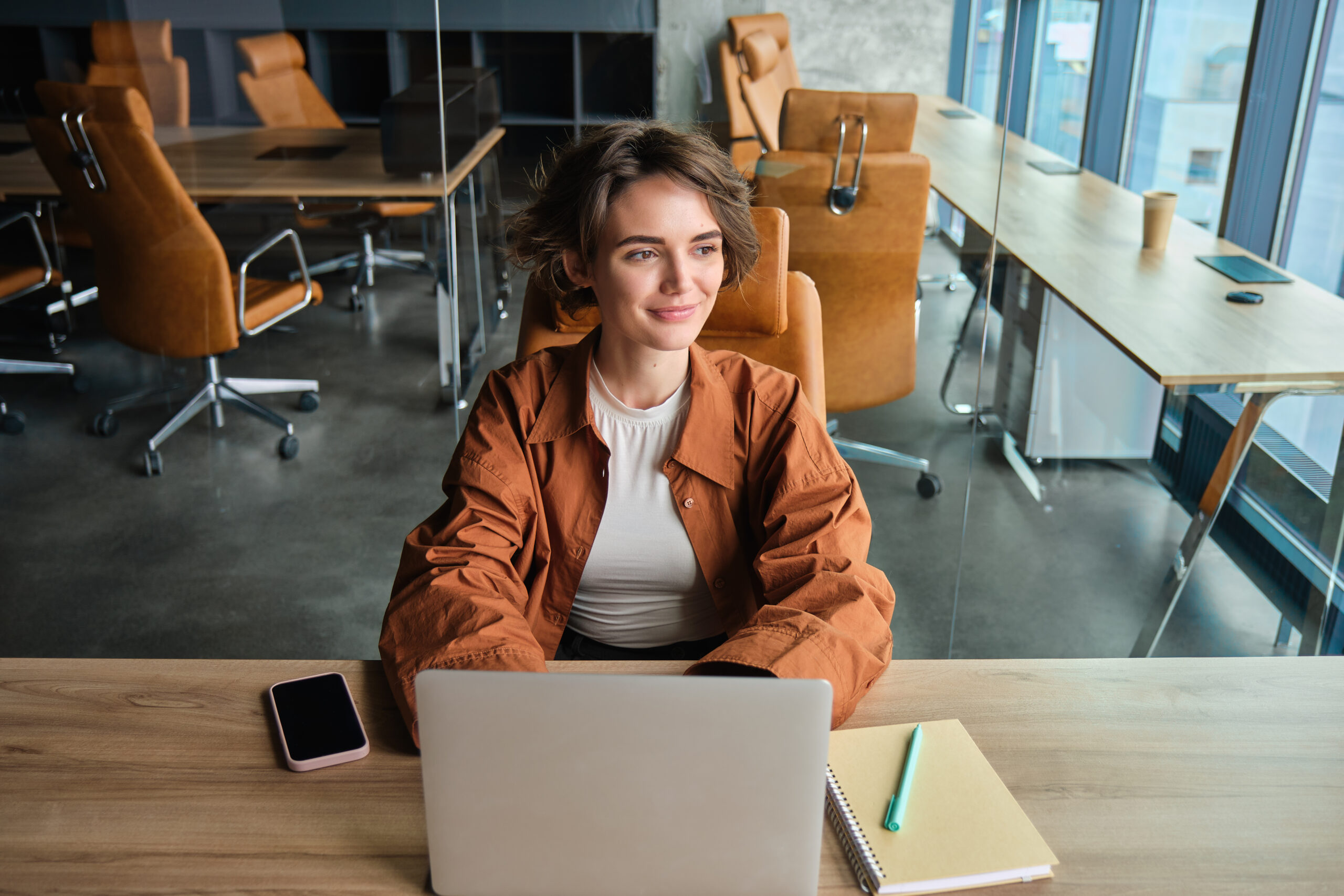 Portrait of woman working in office sitting at table with laptop girl programmer coding in coworking